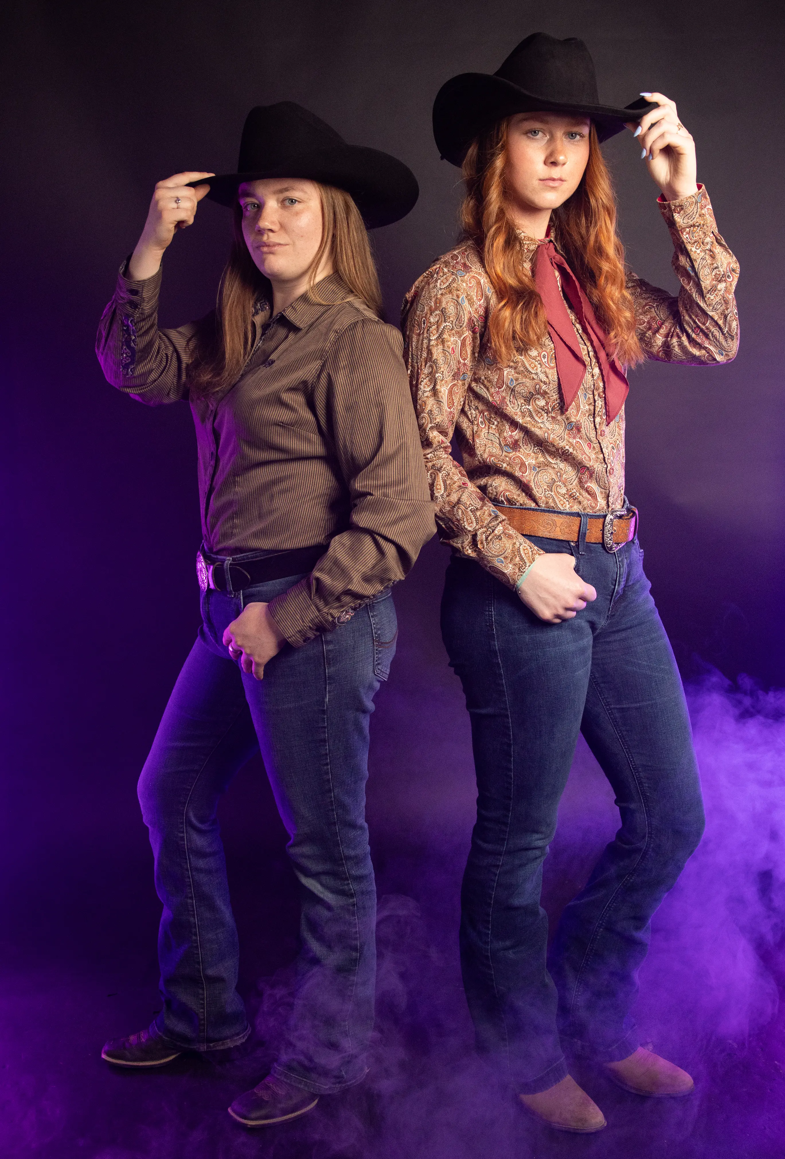 two western riders pose for a photo