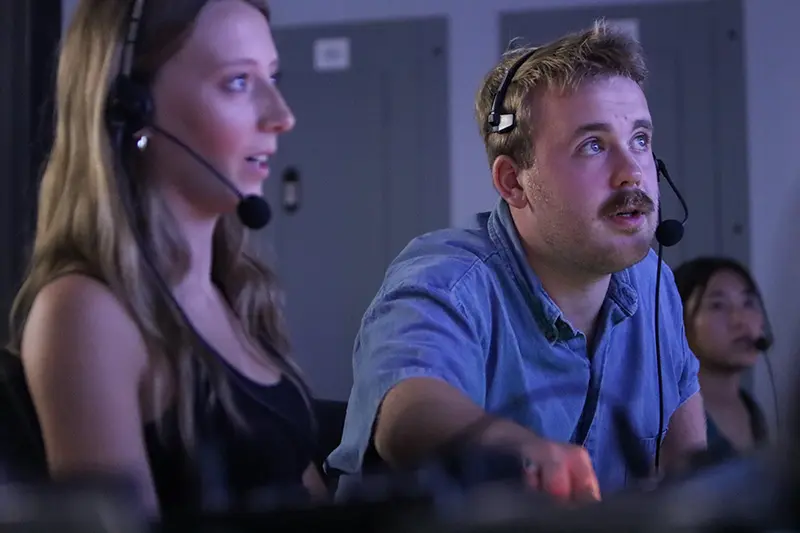 student with headset on film set