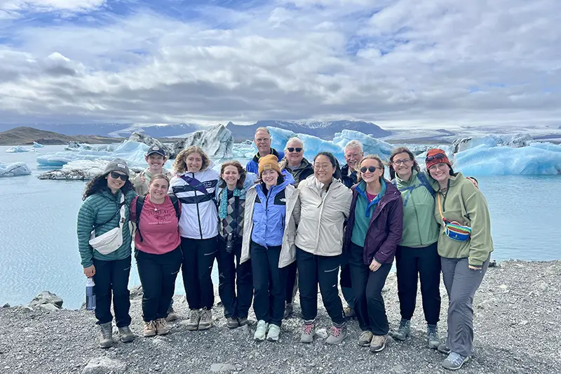 group photo in front of iceberg