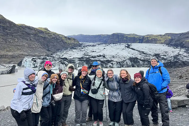 group in front of rock