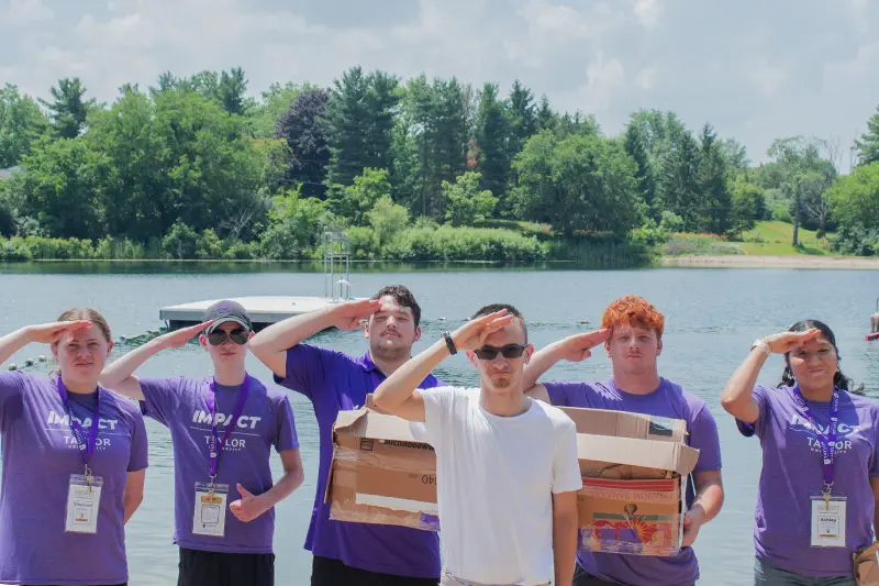 team salutes at lake for boat race