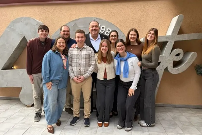 Kosovo team posing outside company
