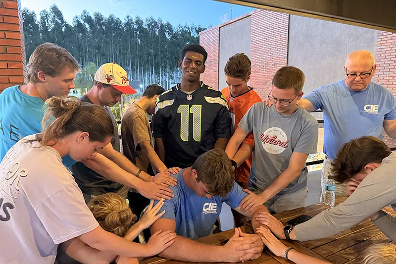 Paraguay team praying for team member