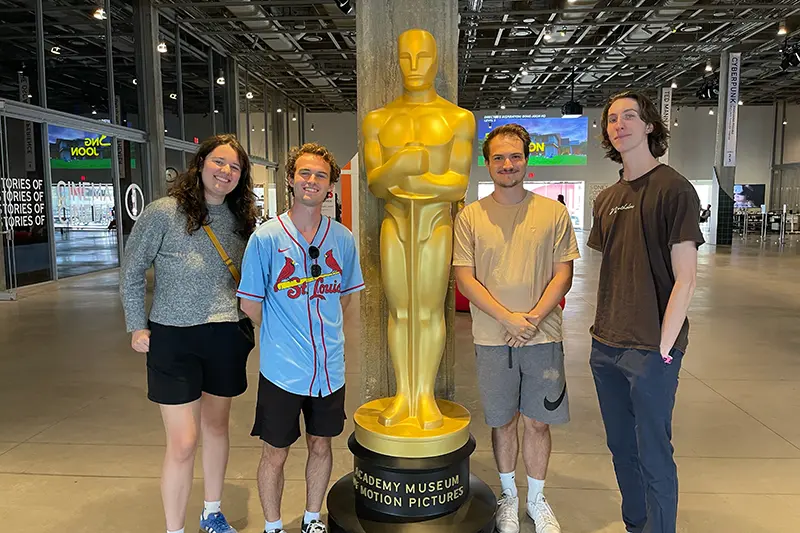 student holds film camera on set