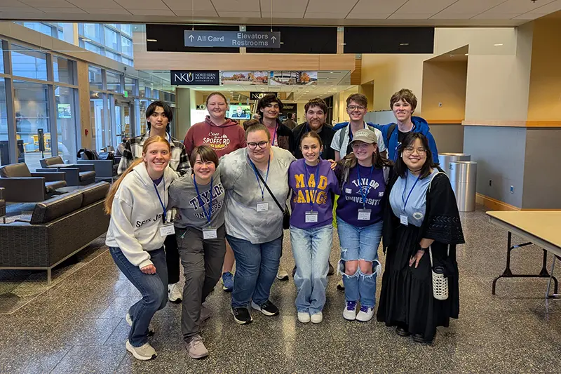 group of 12 students pose 