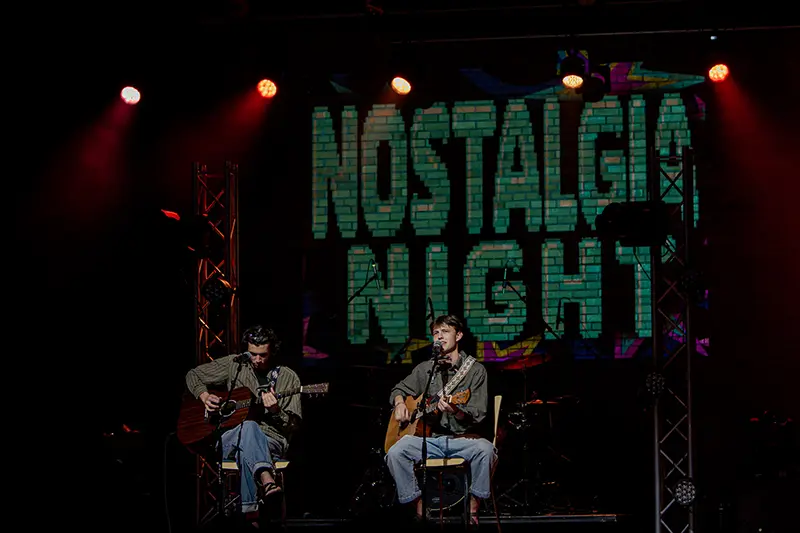 duo act with nostalgia night projected in background