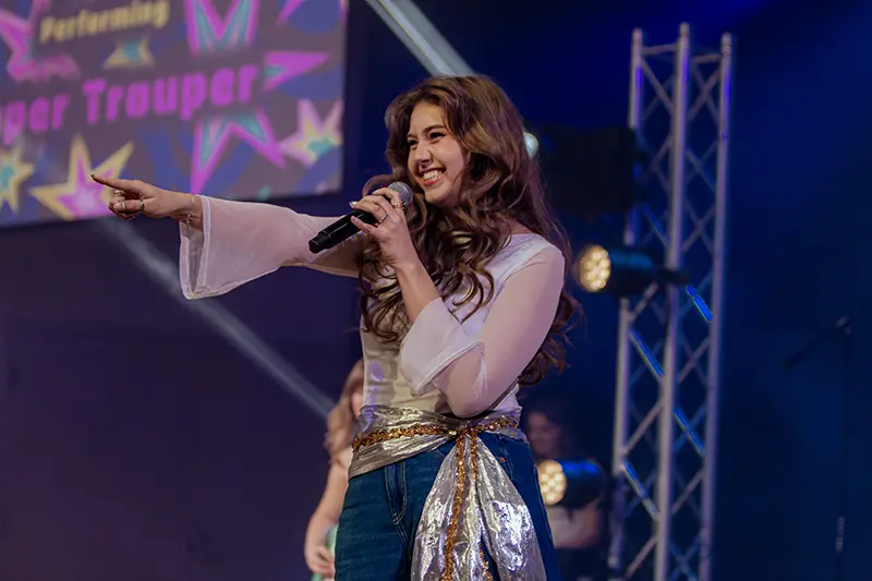 Girl singing and pointing