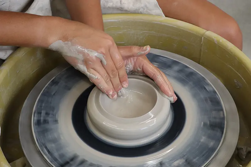 close up photo of a pot on the wheel