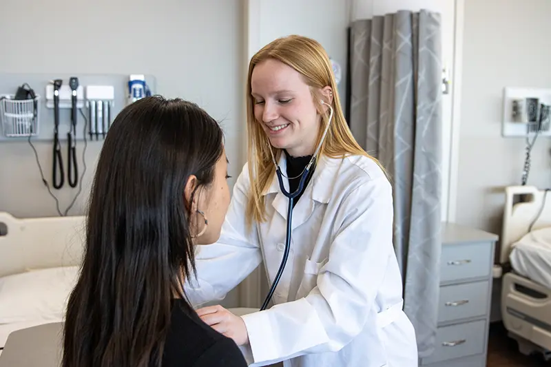 girl listening to patient's heartbeat