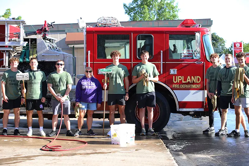 students cleaning a fire engine