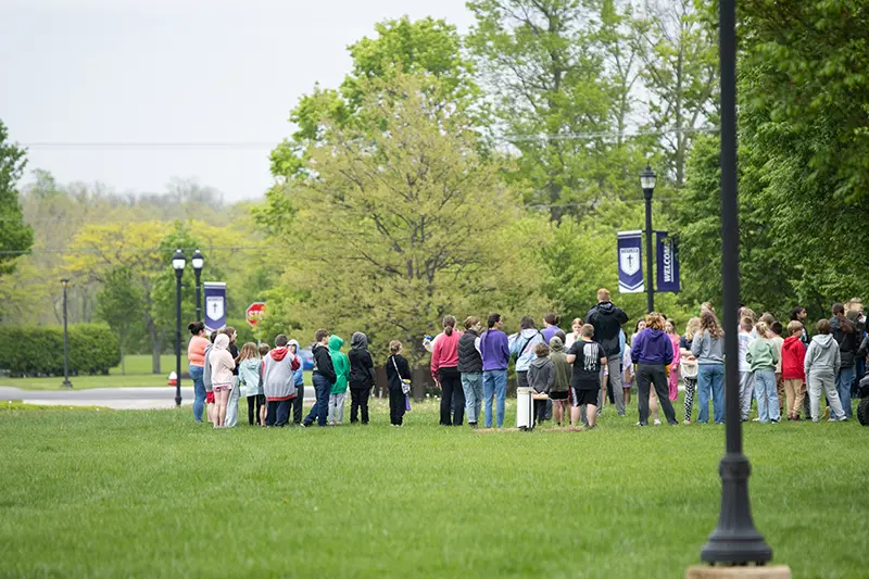 elementary students gather on campus outside