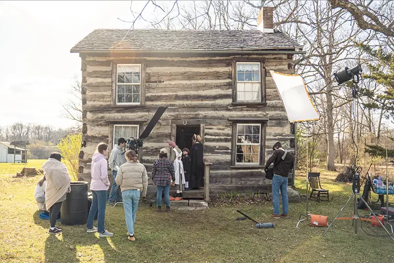 student filmmakers outside a log cabin