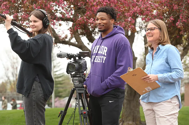 students and professor filming