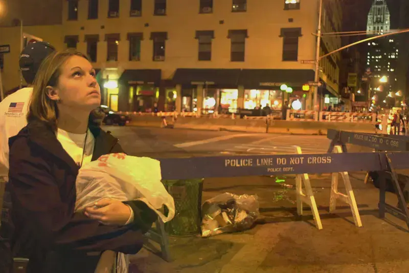female student looking up at 9/11 damage